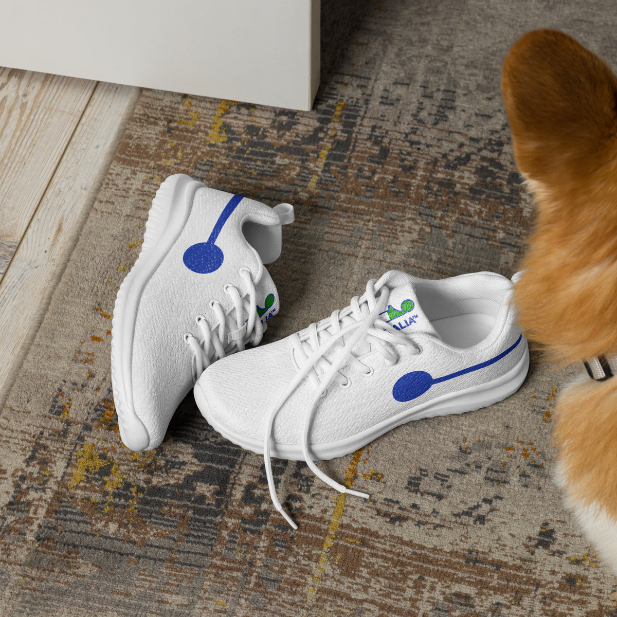 àthlon La Italia™ men's white sneakers, lightweight, soft and comfortable, with blue side graphics, on a rug beside a dog.