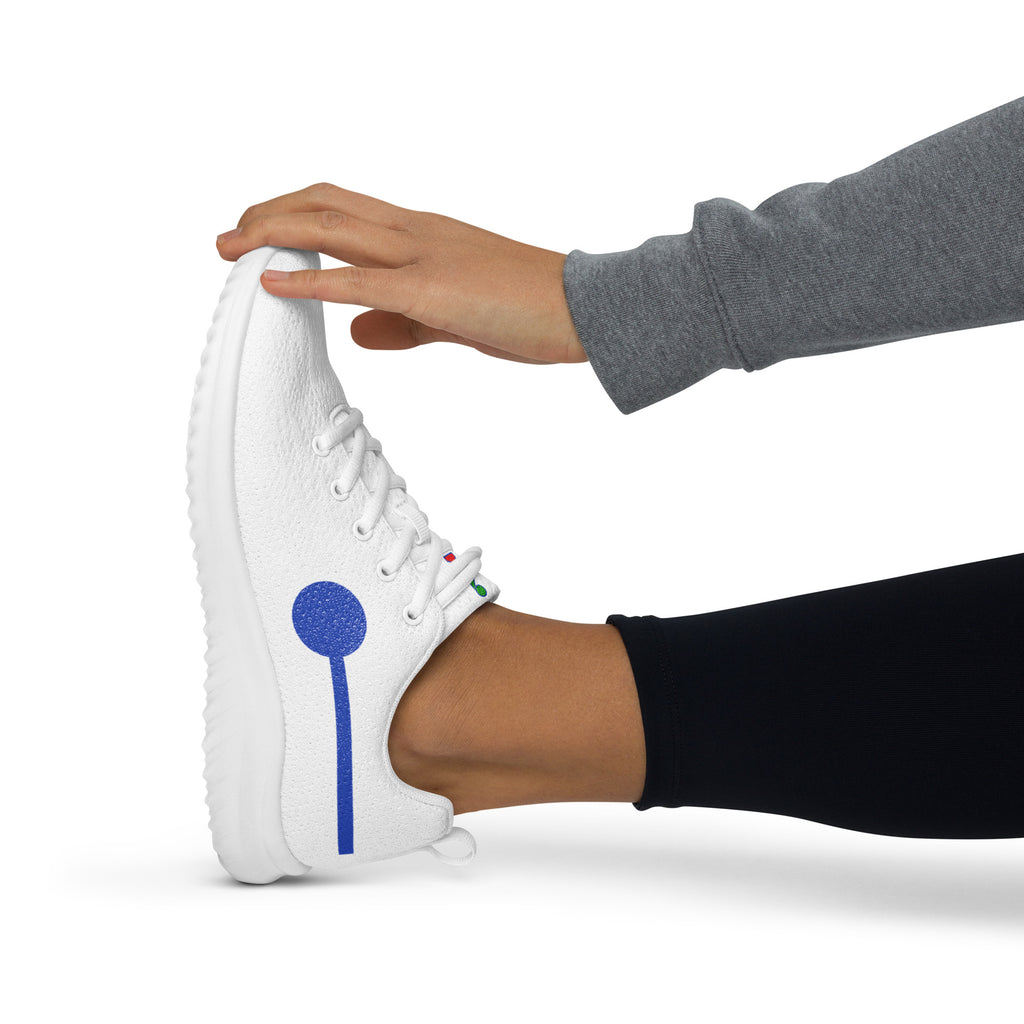 àthlon La Italia™ women's white sneaker, side view worn with black leggings, with a hand bending the toe to show excellent flexibility.